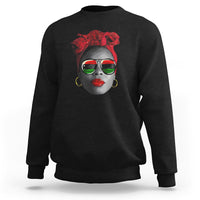 Women’s black sweatshirt with red patterned face graphic at chest