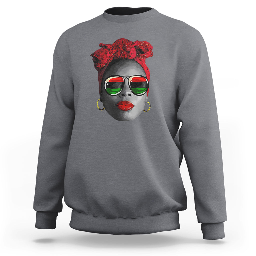 Women’s charcoal gray sweatshirt with red patterned face graphic at chest