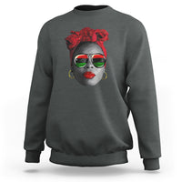 Women’s dark heather gray sweatshirt with red patterned face graphic at chest