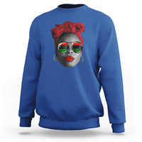 Women’s royal blue sweatshirt with red patterned face graphic at chest