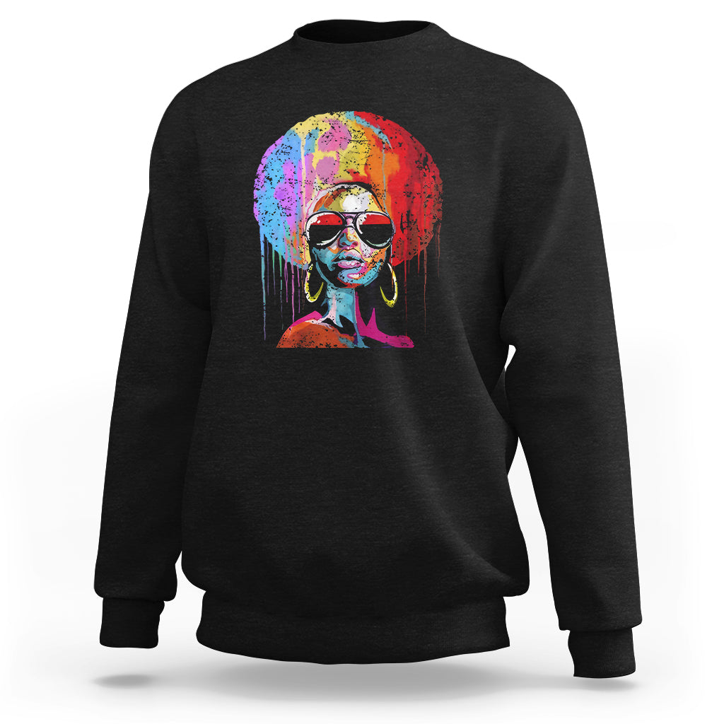 Women’s black crewneck sweatshirt with colorful afro portrait graphic on front.