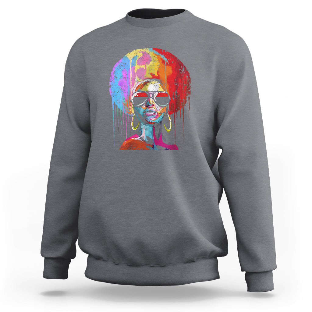 Women’s charcoal crewneck sweatshirt with colorful afro portrait graphic on front.