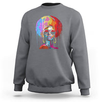 Women’s charcoal crewneck sweatshirt with colorful afro portrait graphic on front.