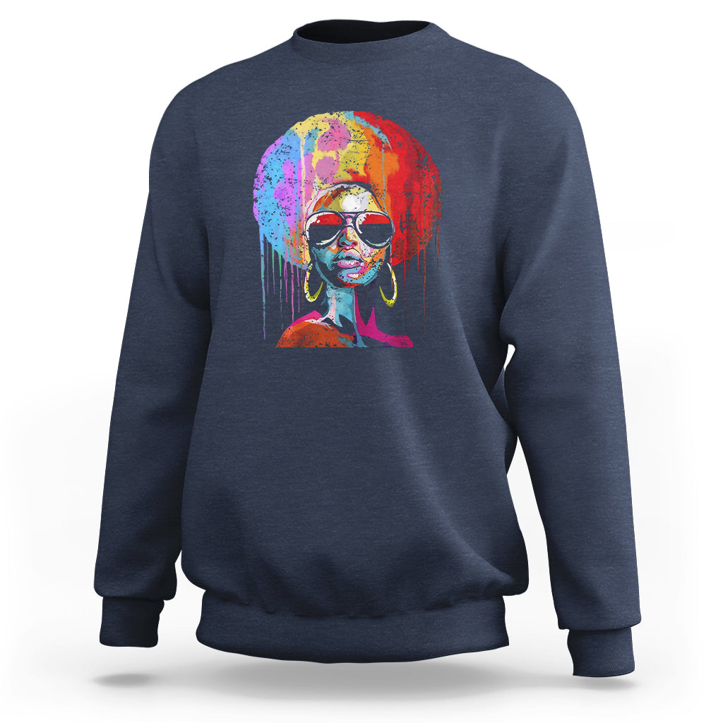 Women’s navy crewneck sweatshirt with colorful afro portrait graphic on front.