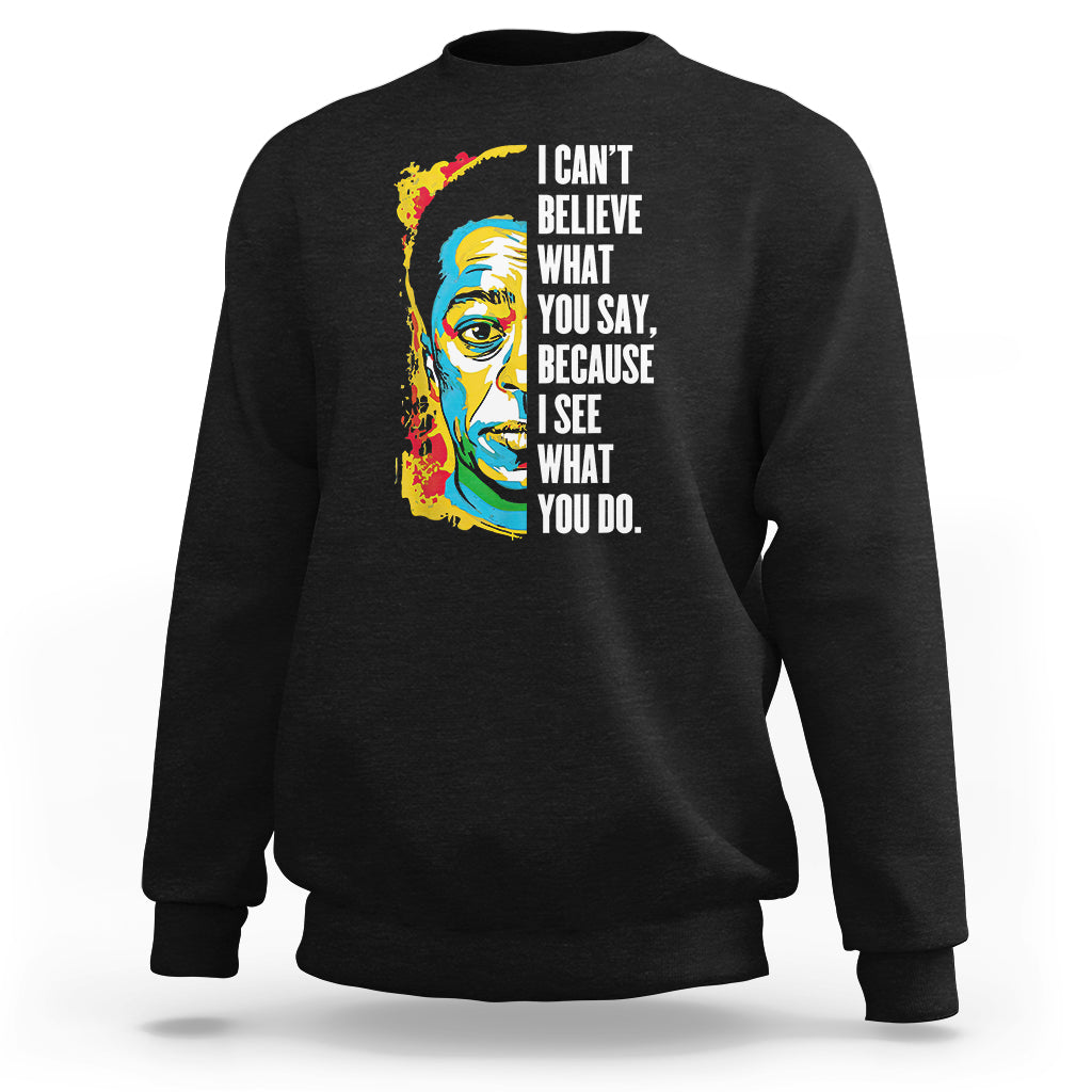 Black crewneck sweatshirt with colorful portrait graphic and quote on front