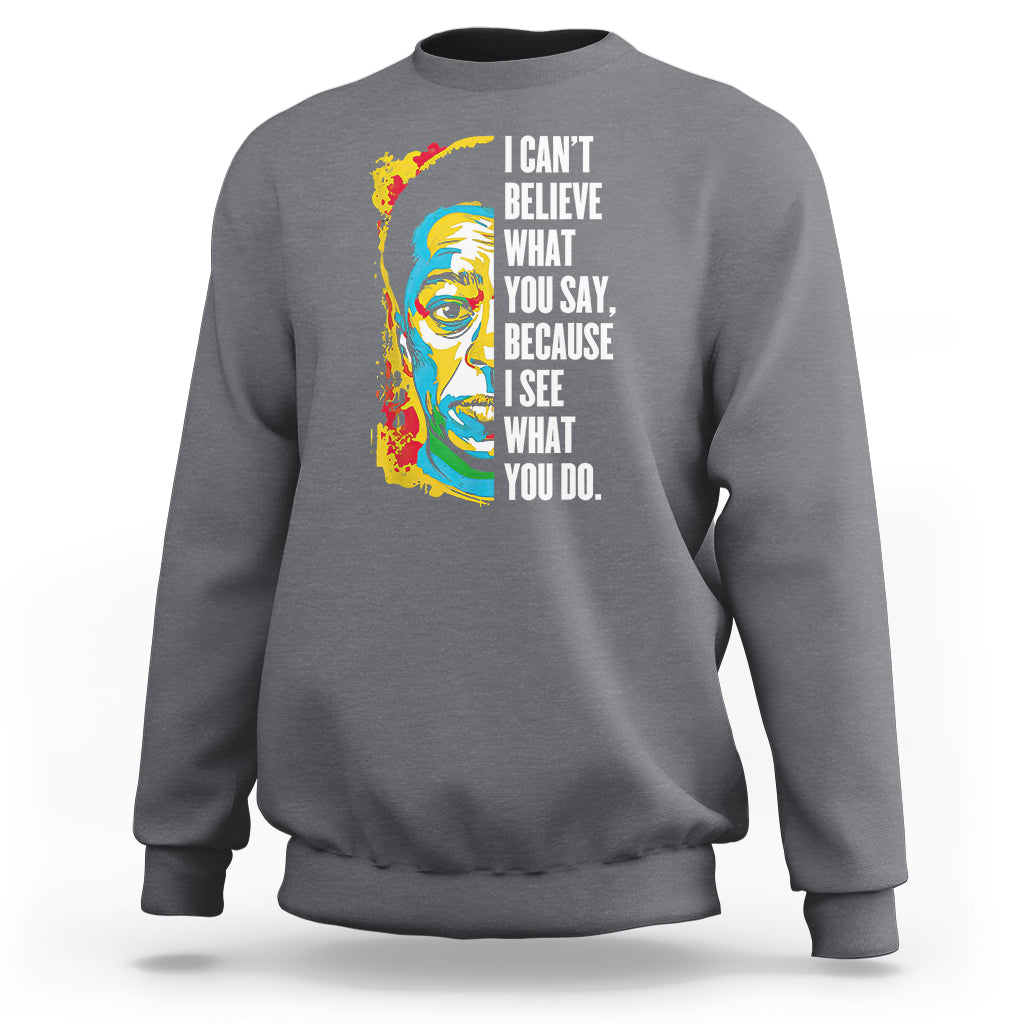 Charcoal crewneck sweatshirt with colorful portrait graphic and quote on front