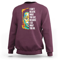 Maroon crewneck sweatshirt with colorful portrait graphic and quote on front