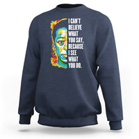 Navy crewneck sweatshirt with colorful portrait graphic and quote on front