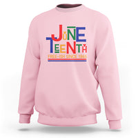 Light pink crewneck sweatshirt with multicolor Juneteenth graphic, 'FREE-ISH SINCE 1865'