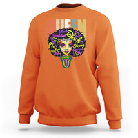 Orange crewneck sweatshirt with multicolor queen portrait graphic on front