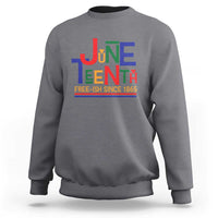 Heather gray crewneck sweatshirt with retro Juneteenth graphic and “FREE-ISH SINCE 1865”.