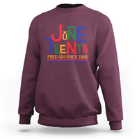 Maroon crewneck sweatshirt with retro Juneteenth graphic and “FREE-ISH SINCE 1865”.