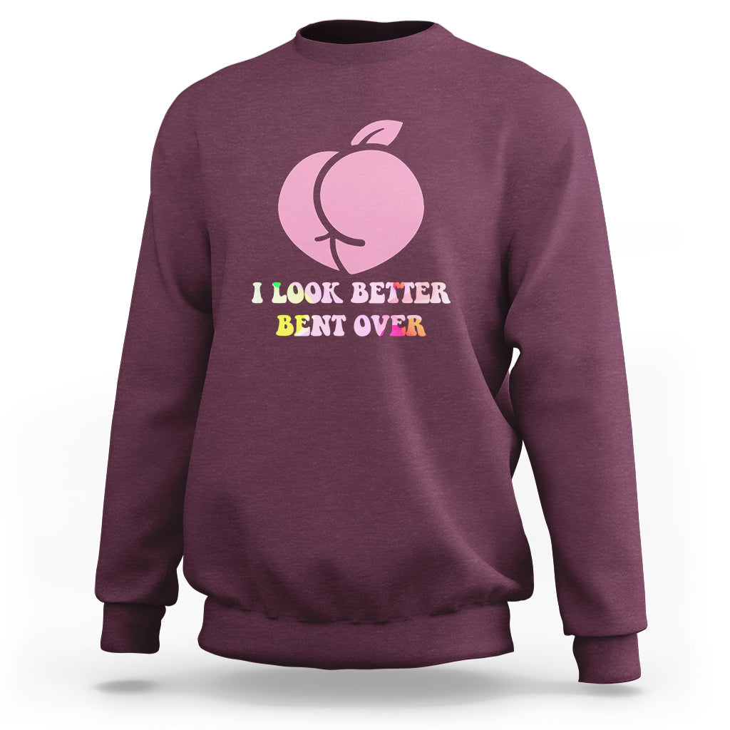 Maroon crewneck sweatshirt with pink apple logo and 'I look better bent over' print