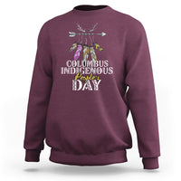 Maroon crewneck sweatshirt with colorful feathered deer graphic and event text print