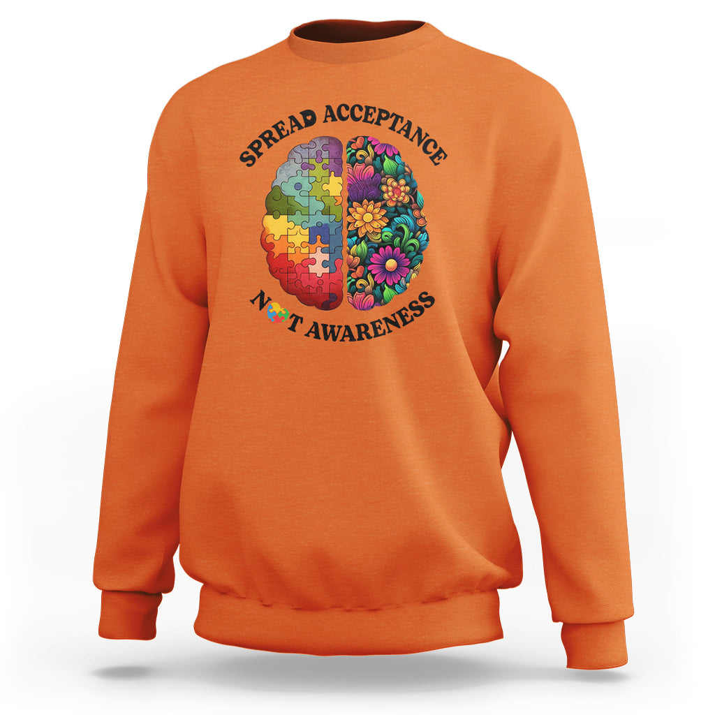 Orange crewneck sweatshirt with colorful puzzle brain heart graphic
