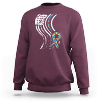 Maroon sweatshirt with autism awareness ribbon graphic and American flag stripes on back