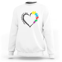 White autism awareness sweatshirt with heart-and-puzzle graphic on chest.