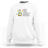 White autism definition sweatshirt with multicolor puzzle hand graphic and text