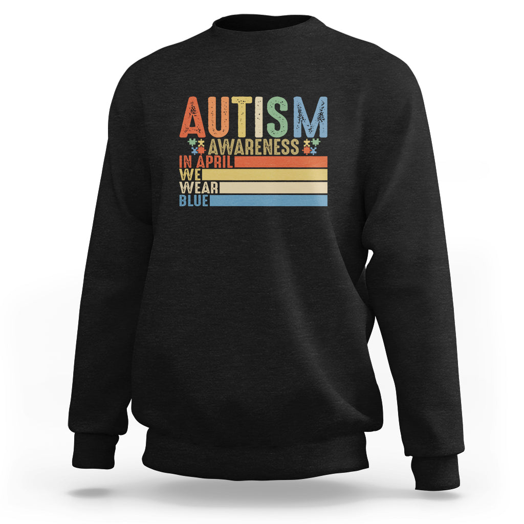 Black autism awareness sweatshirt with retro puzzle piece and “We wear blue” graphic