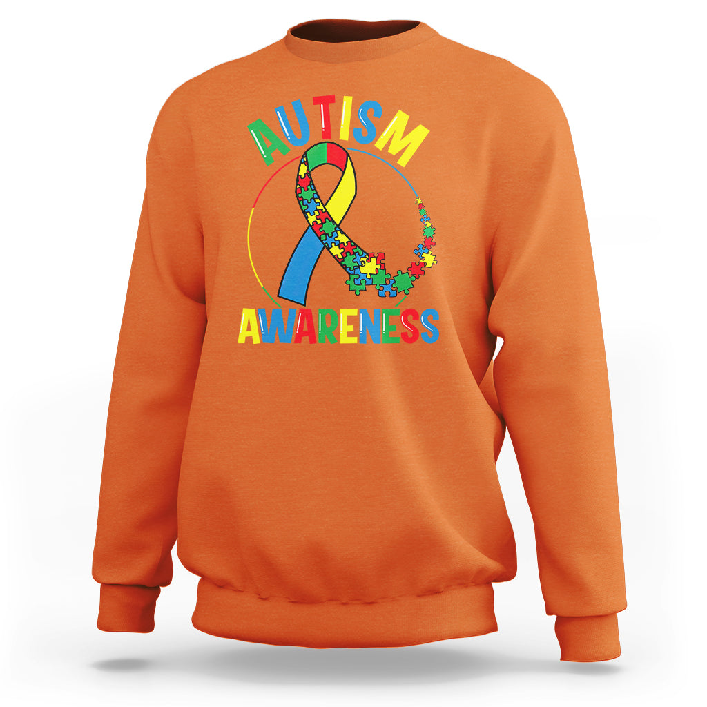 Orange autism awareness sweatshirt with multicolor puzzle ribbon graphic on front