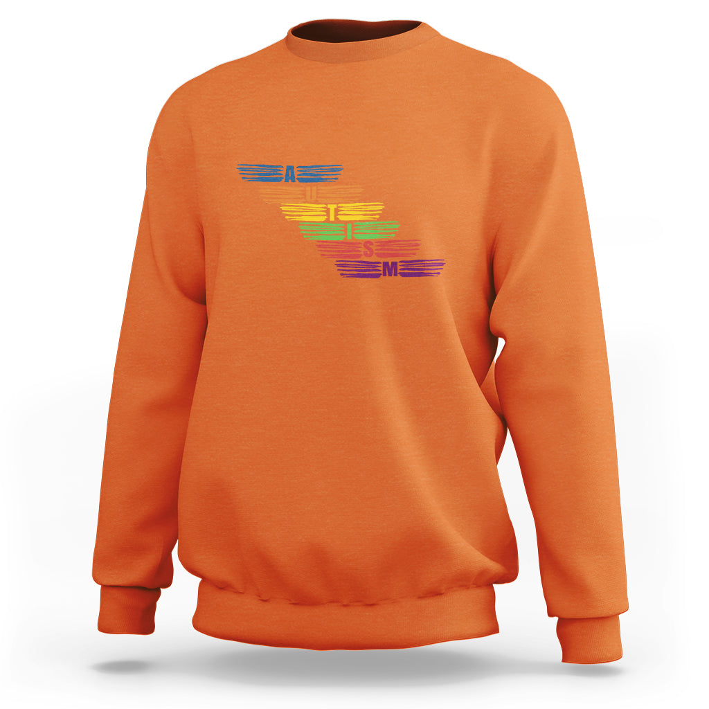 Orange crewneck sweatshirt with multicolor autism awareness typography graphic