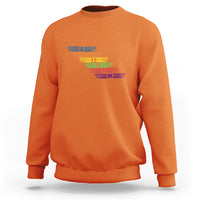 Orange crewneck sweatshirt with multicolor autism awareness typography graphic