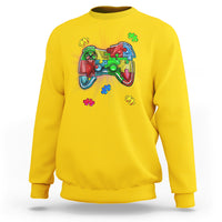 Yellow crewneck sweatshirt with colorful game controller autism puzzle graphic