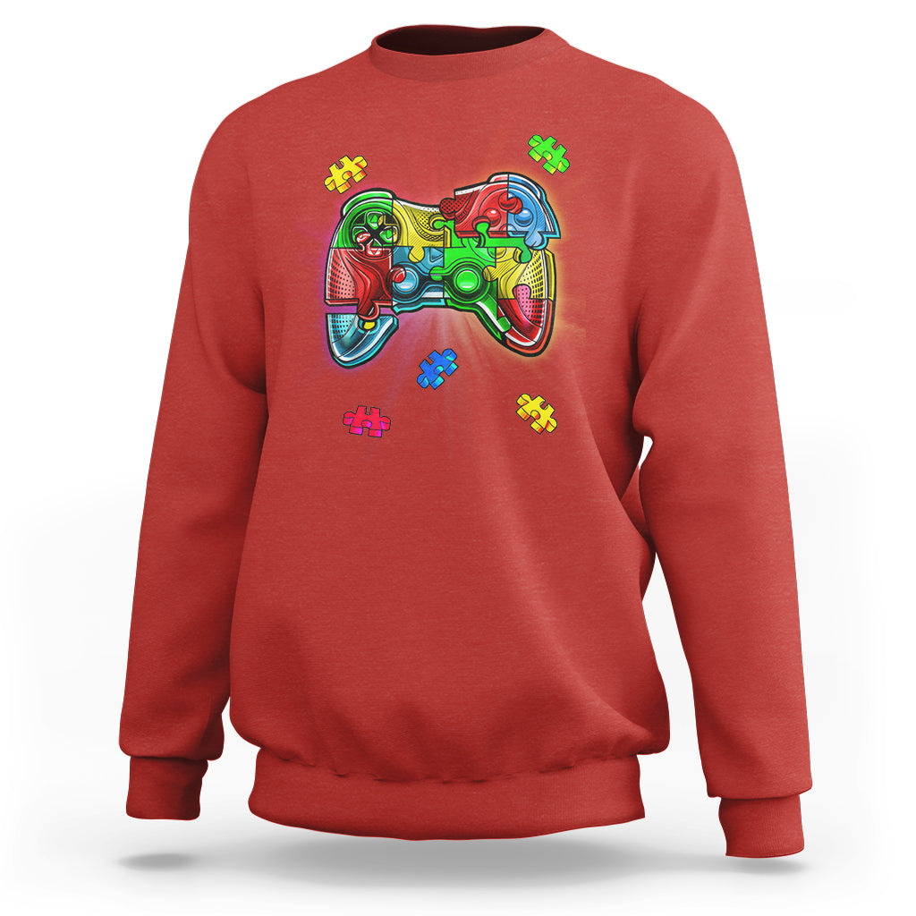 Red crewneck sweatshirt with colorful game controller autism puzzle graphic
