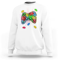 White crewneck sweatshirt with colorful game controller autism puzzle graphic