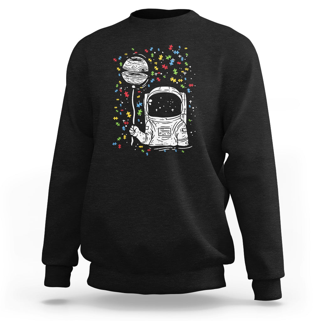 Black sweatshirt with astronaut graphic and colorful starburst print