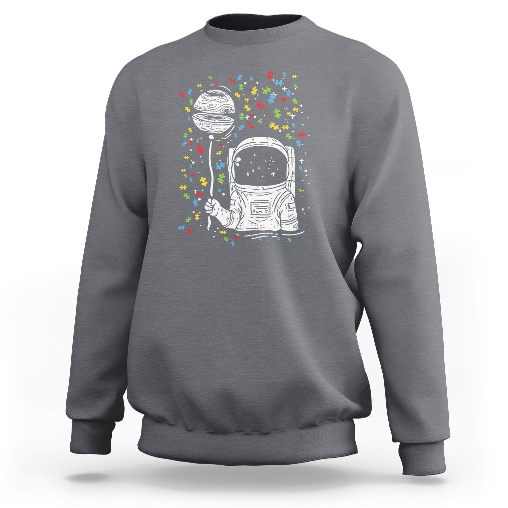 Charcoal gray sweatshirt with astronaut graphic and colorful starburst print