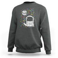 Dark heather gray sweatshirt with astronaut graphic and colorful starburst print