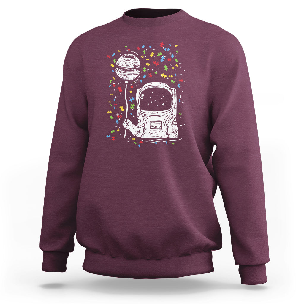Maroon sweatshirt with astronaut graphic and colorful starburst print