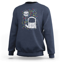 Navy sweatshirt with astronaut graphic and colorful starburst print