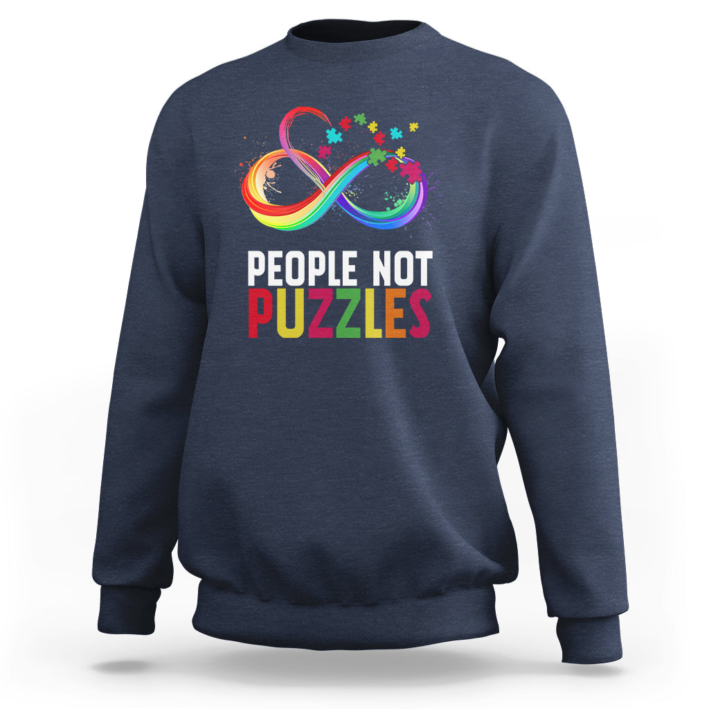 Navy crewneck sweatshirt with “People Not Puzzles” rainbow infinity graphic