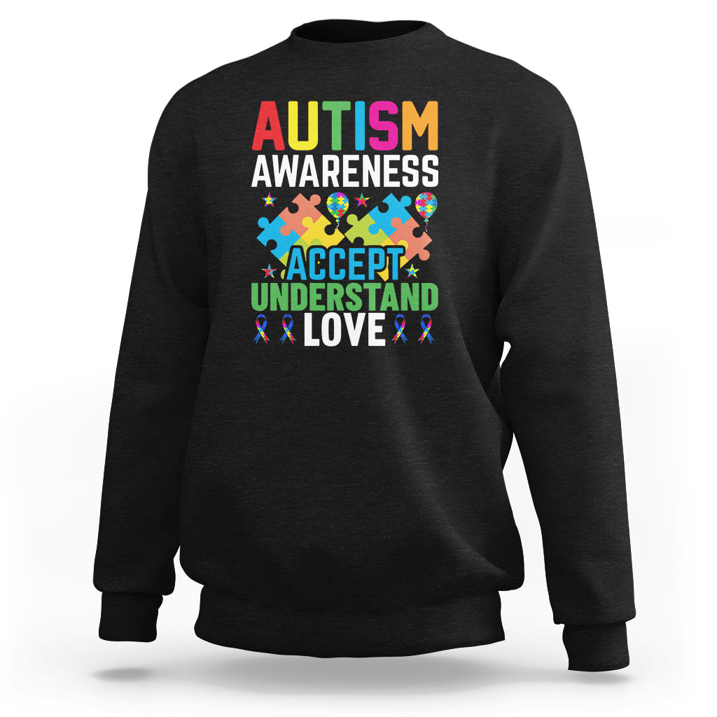 Autism awareness sweatshirt, black, with colorful 'Accept Understand Love' ribbon graphic.