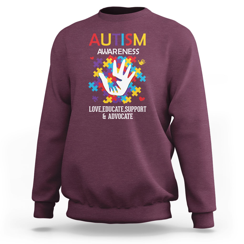 Autism awareness sweatshirt, maroon crewneck with colorful puzzle-hand graphic and text