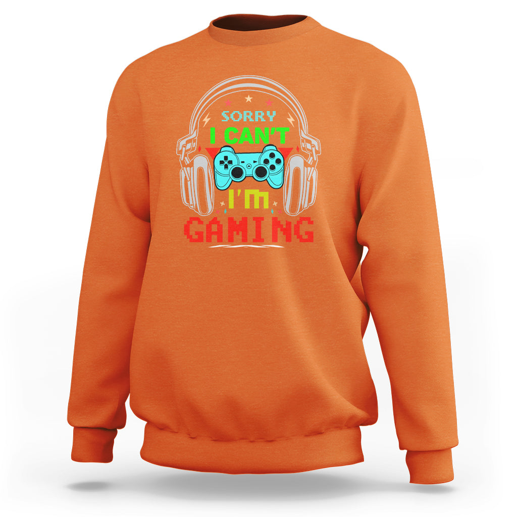 Orange sweatshirt with 'Sorry I can't I'm gaming' headset gamepad graphic