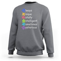 Autism definition sweatshirt, heather gray crewneck with colorful text and puzzle icons