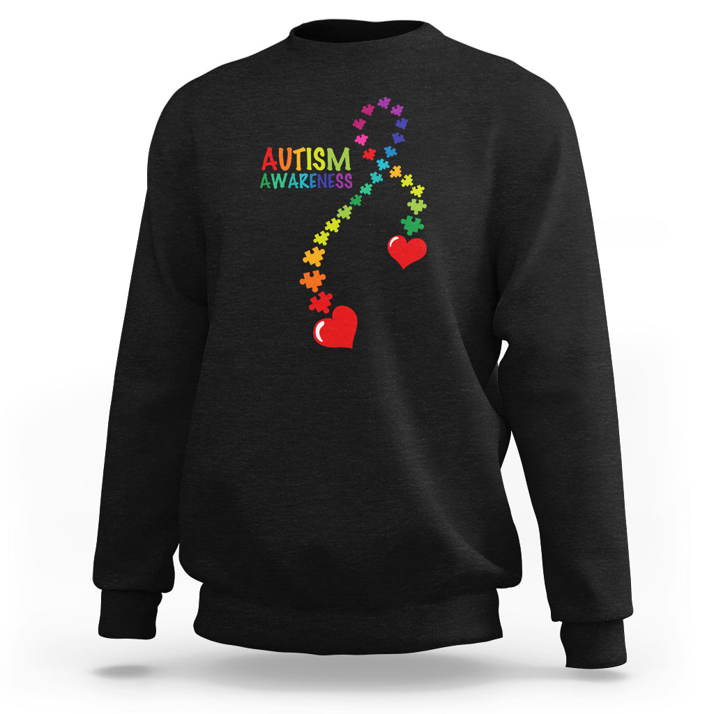 Black sweatshirt with autism awareness puzzle heart and ribbon graphic, crewneck.