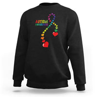 Black sweatshirt with autism awareness puzzle heart and ribbon graphic, crewneck.