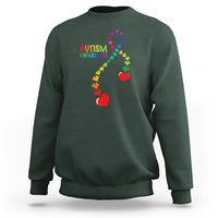 Dark forest green sweatshirt with autism awareness puzzle heart and ribbon graphic.