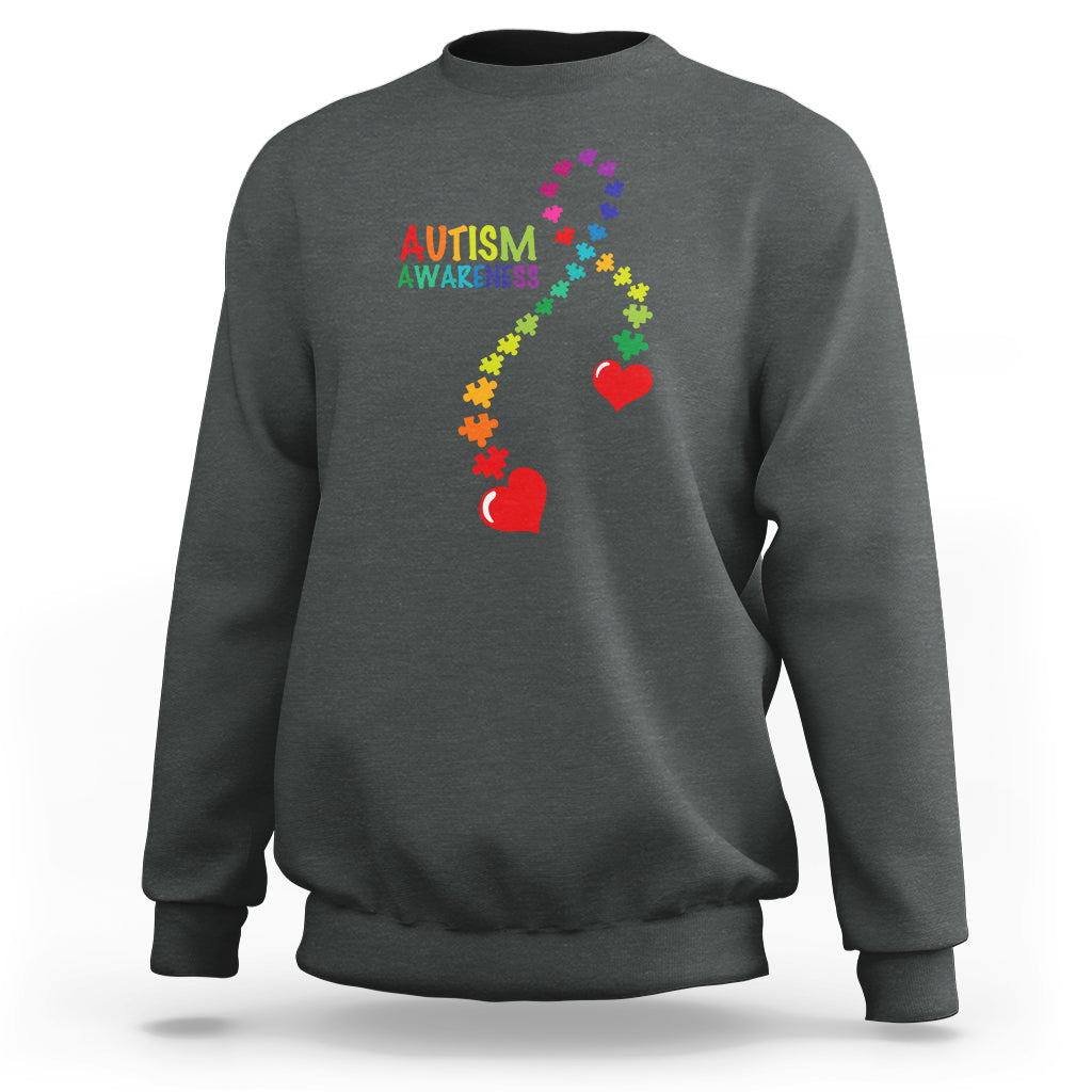 Charcoal gray sweatshirt with autism awareness puzzle heart and ribbon graphic, crewneck.