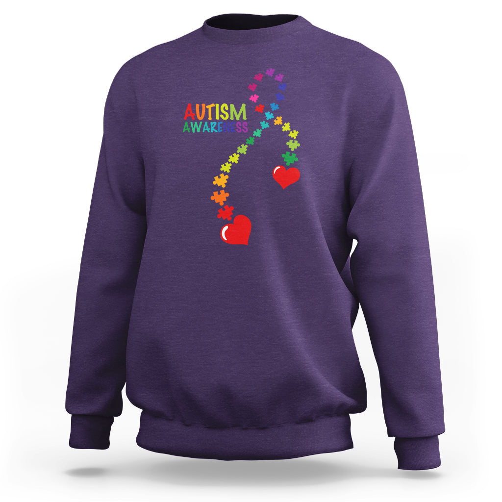 Purple sweatshirt with autism awareness puzzle heart and ribbon graphic, crewneck.