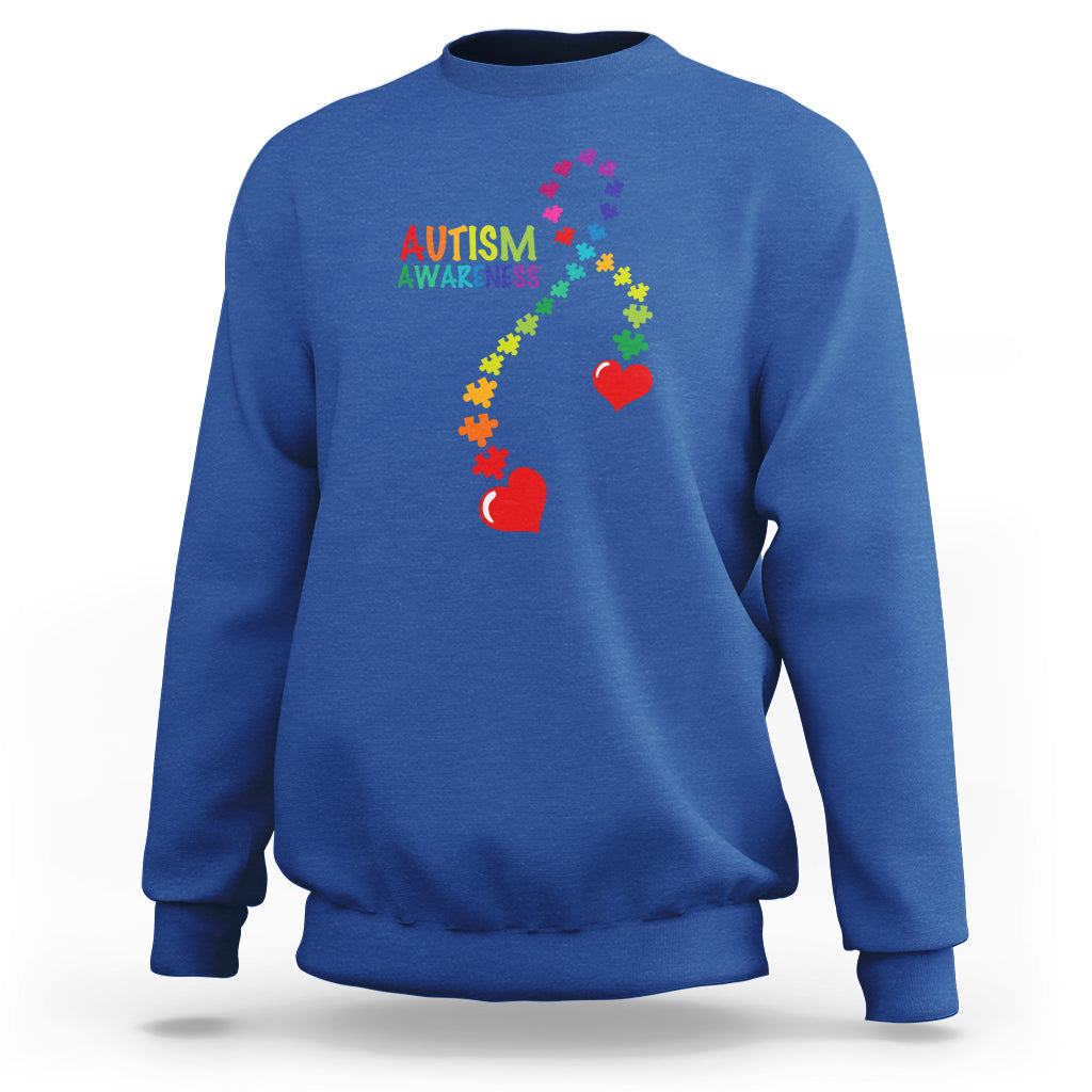 Royal blue sweatshirt with autism awareness puzzle heart and ribbon graphic, crewneck.