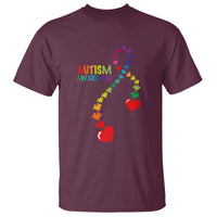 Maroon autism awareness T-shirt with puzzle-heart ribbon and red heart icons