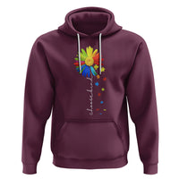 Maroon hoodie with sunflower and colorful puzzle-piece ribbon graphic, front kangaroo pocket