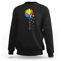 Black crewneck sweatshirt with colorful sunflower and rainbow puzzle graphic on chest