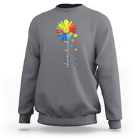 Gray crewneck sweatshirt with colorful sunflower and rainbow puzzle graphic on chest