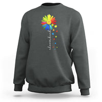 Heather gray crewneck sweatshirt with colorful sunflower and rainbow puzzle graphic on chest